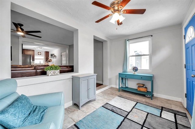 living room with a textured ceiling and ceiling fan