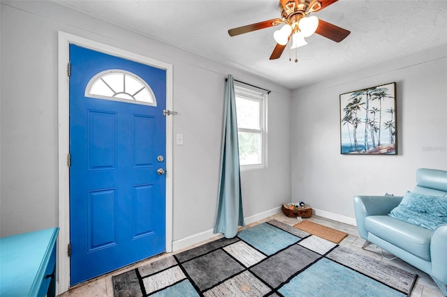 foyer featuring ceiling fan and plenty of natural light