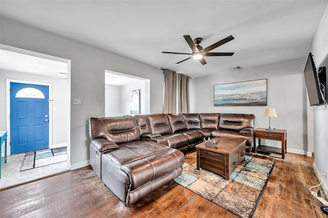 living room with ceiling fan and hardwood / wood-style flooring