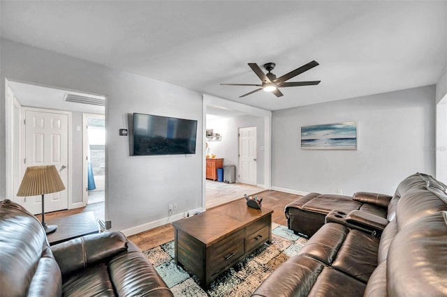 living room featuring light wood-type flooring and ceiling fan