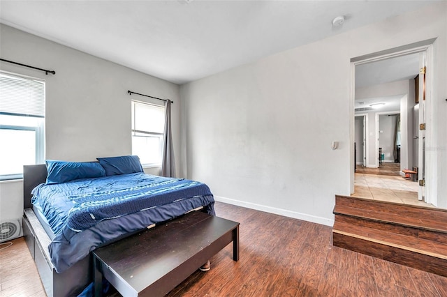 bedroom featuring hardwood / wood-style floors and multiple windows