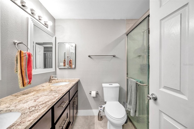 bathroom with an enclosed shower, vanity, and toilet