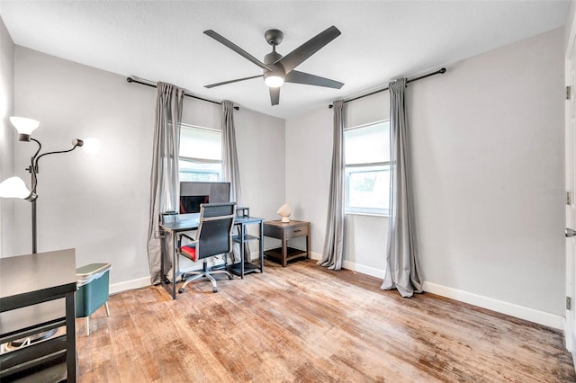 office with ceiling fan and light wood-type flooring