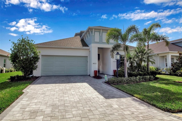 view of front facade with a garage and a front lawn