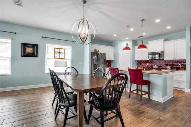 dining room featuring dark hardwood / wood-style flooring and a chandelier