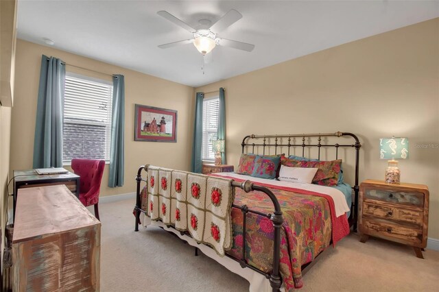 bedroom with ceiling fan and light carpet