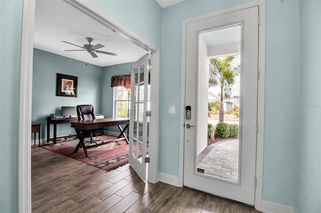 doorway to outside with wood-type flooring and ceiling fan