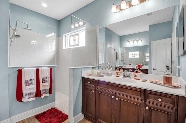 bathroom with vanity and tiled shower