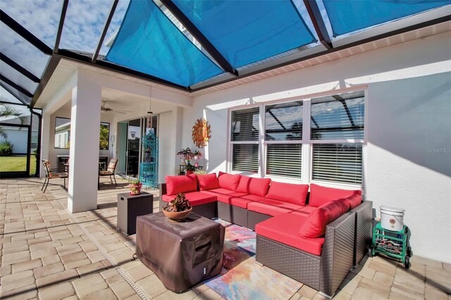 view of patio with an outdoor living space, a lanai, and ceiling fan