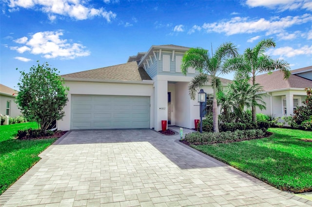 view of front of home with a garage and a front yard