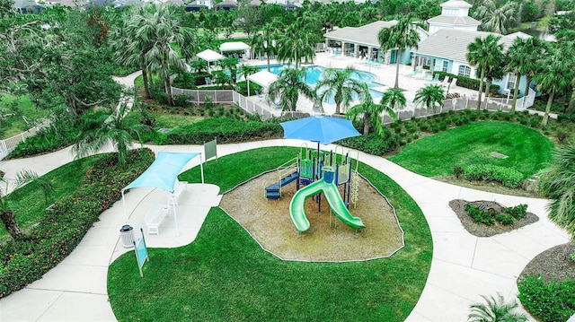 view of home's community featuring a playground and a yard