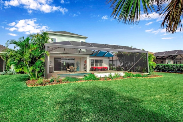 rear view of property featuring a patio, glass enclosure, and a lawn