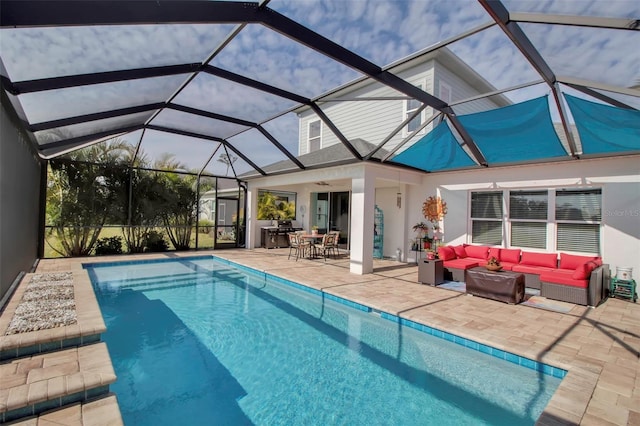 view of swimming pool with ceiling fan, an outdoor hangout area, glass enclosure, and a patio area