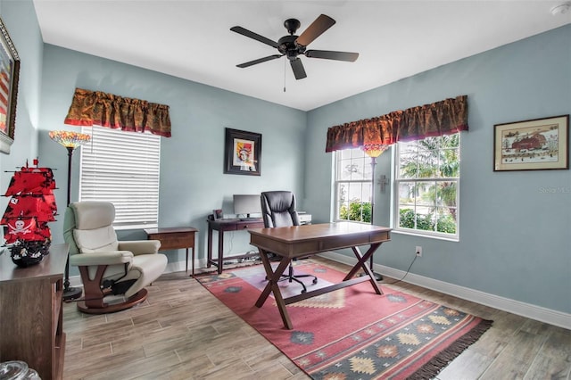 home office with wood-type flooring and ceiling fan