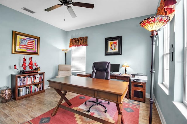 home office with ceiling fan and light hardwood / wood-style floors