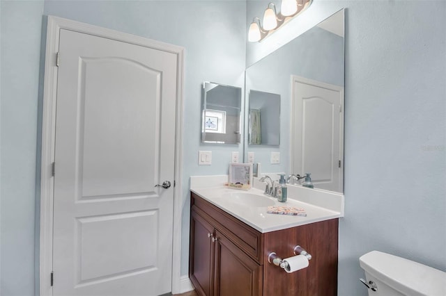 bathroom with vanity and toilet