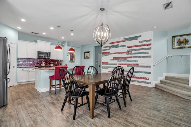 dining area with a chandelier and light wood-type flooring