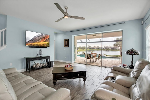 living room featuring hardwood / wood-style flooring and ceiling fan