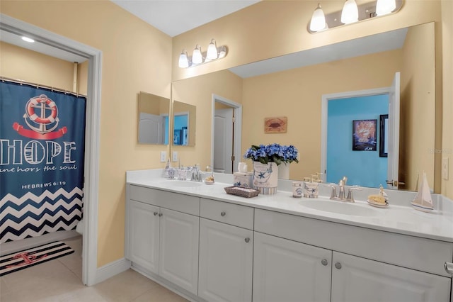 bathroom with walk in shower, tile patterned floors, and vanity