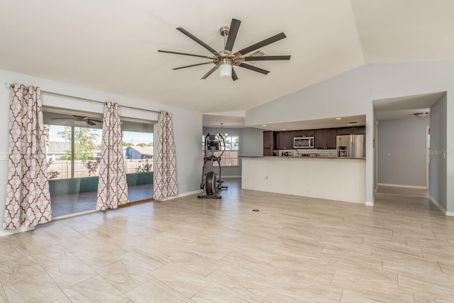 unfurnished living room featuring ceiling fan, lofted ceiling, and a wealth of natural light