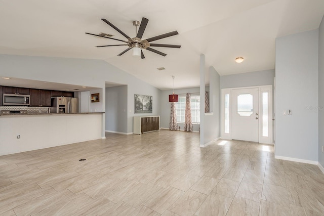 foyer with ceiling fan and lofted ceiling