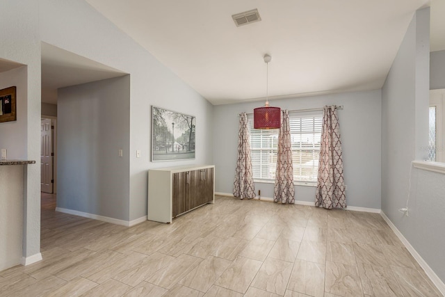 unfurnished room featuring lofted ceiling