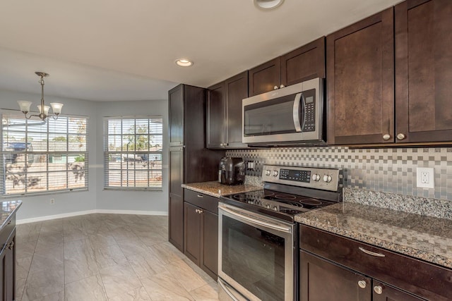 kitchen featuring tasteful backsplash, light stone counters, dark brown cabinetry, stainless steel appliances, and a chandelier