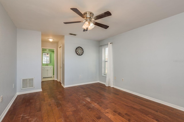 spare room with ceiling fan and dark wood-type flooring