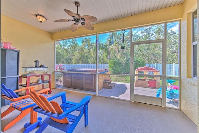 sunroom / solarium with ceiling fan and a healthy amount of sunlight