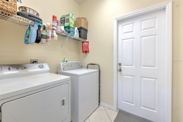 laundry area with light tile patterned flooring and washing machine and clothes dryer