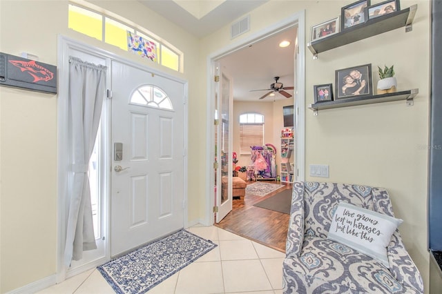 entrance foyer with ceiling fan and light tile patterned floors