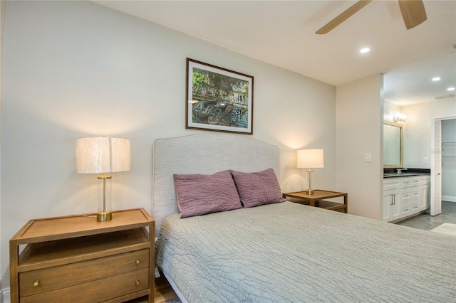 bedroom with ensuite bath, ceiling fan, and sink