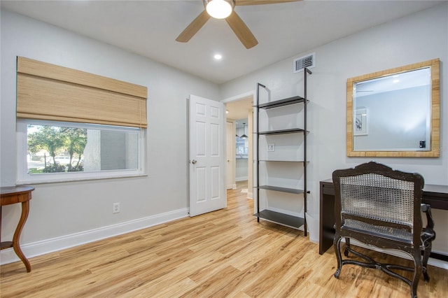 sitting room featuring ceiling fan and light wood-type flooring