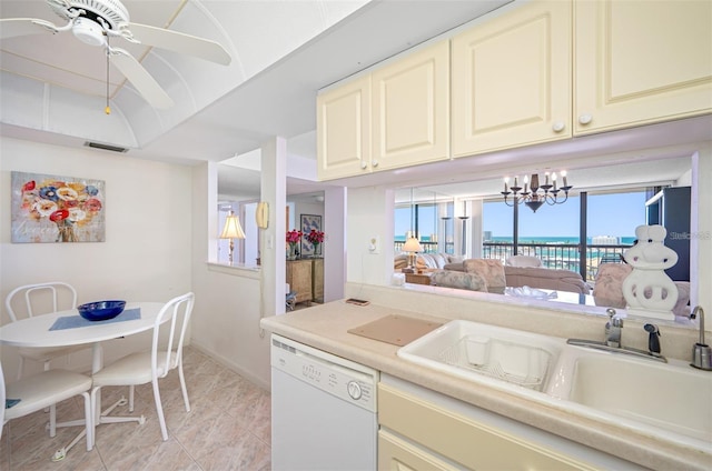 kitchen with dishwasher, sink, and ceiling fan with notable chandelier