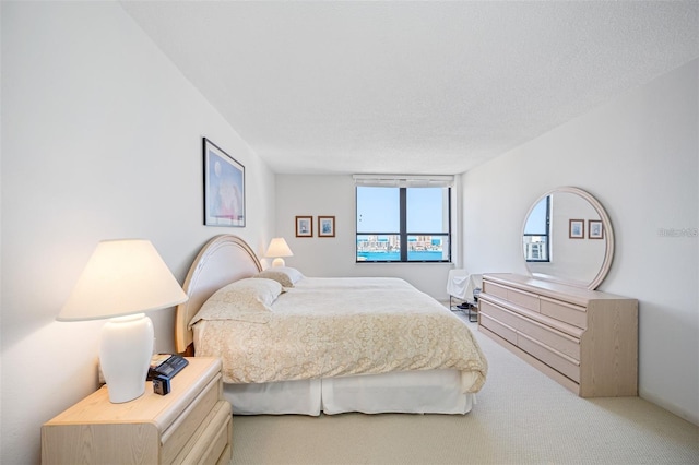 carpeted bedroom featuring a textured ceiling