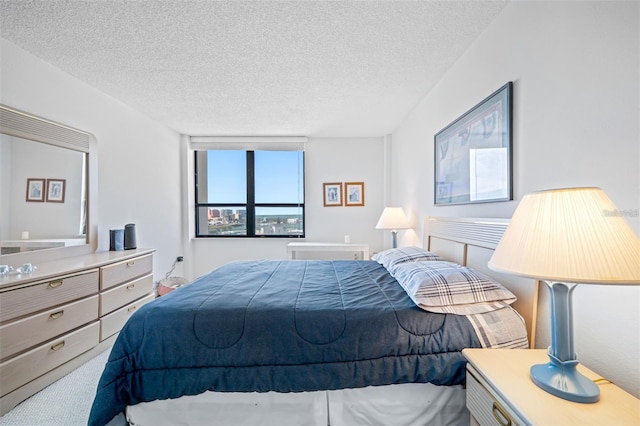 carpeted bedroom with a textured ceiling