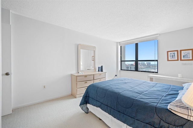 carpeted bedroom with a textured ceiling