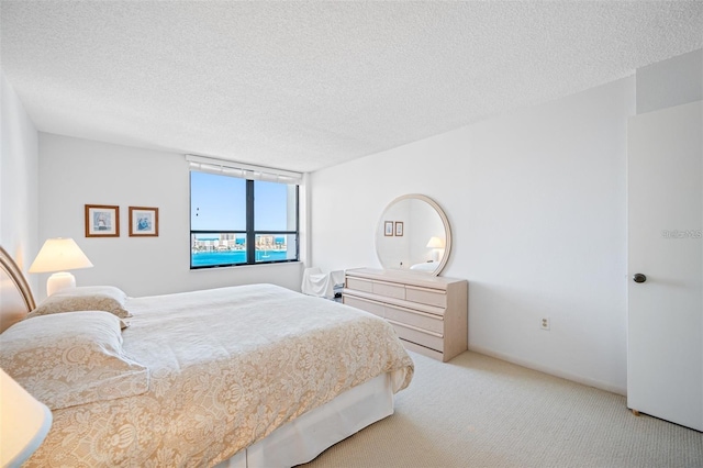 carpeted bedroom featuring a textured ceiling