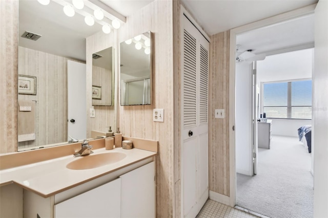 bathroom featuring ceiling fan and vanity