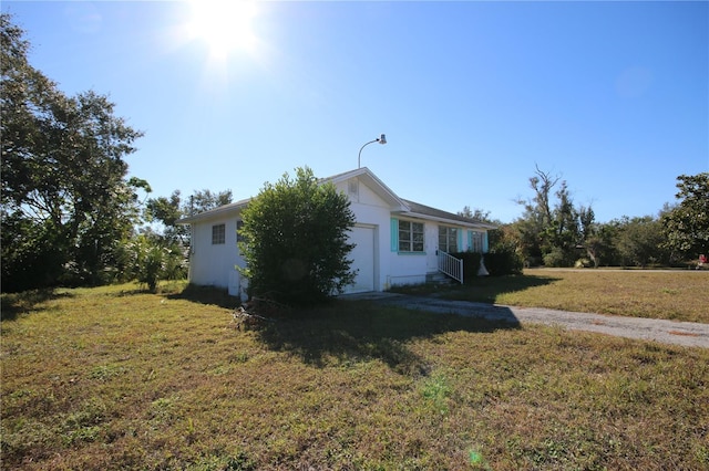 view of home's exterior with a yard and a garage