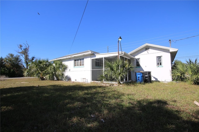 back of property featuring a yard