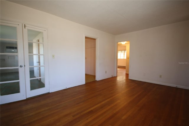 unfurnished room with dark hardwood / wood-style flooring and french doors