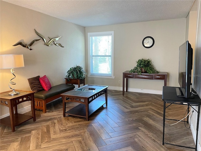 living room featuring a textured ceiling and dark parquet floors