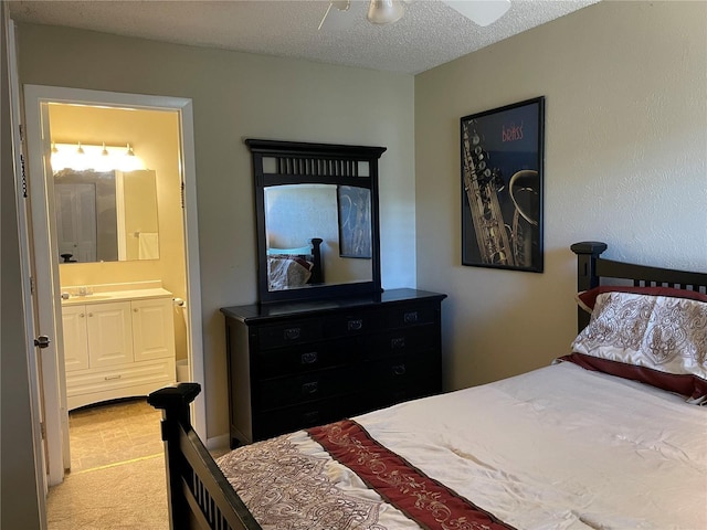 carpeted bedroom featuring connected bathroom, ceiling fan, and a textured ceiling