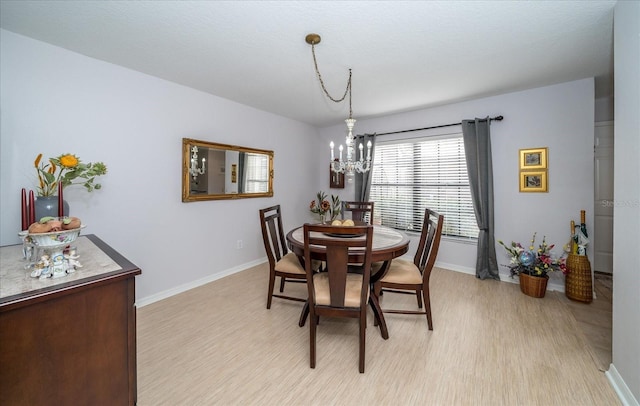 dining area featuring a chandelier and light hardwood / wood-style flooring