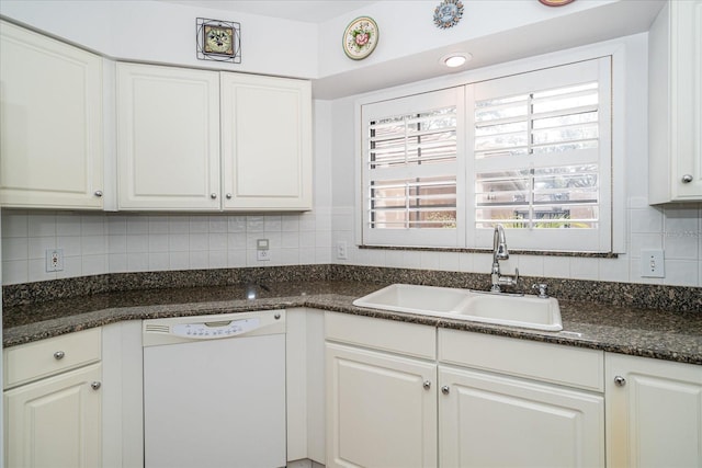 kitchen with backsplash, white cabinets, dark stone counters, sink, and dishwasher