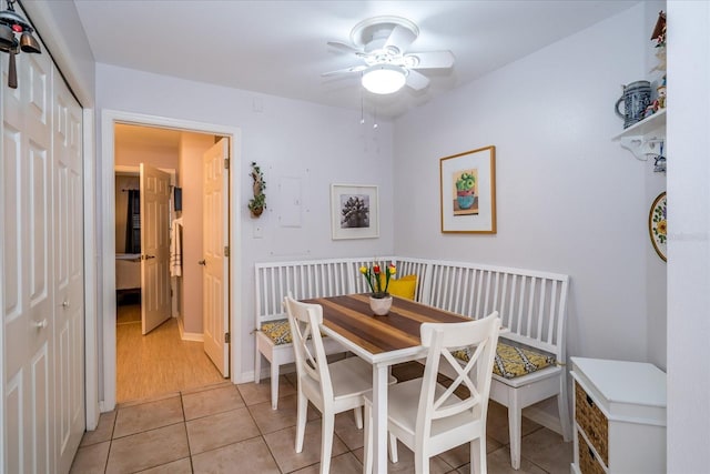 tiled dining area with ceiling fan