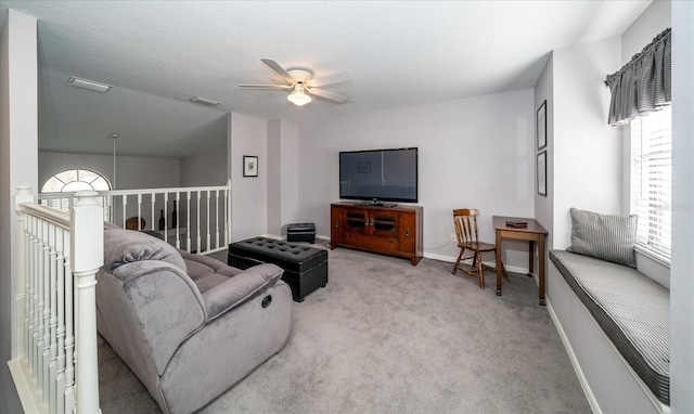 carpeted living room featuring ceiling fan