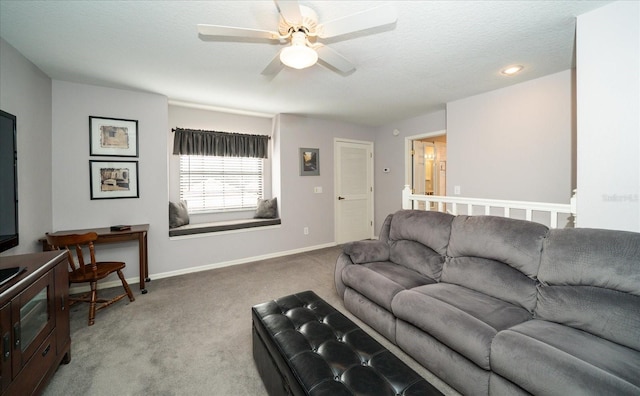 carpeted living room featuring a textured ceiling and ceiling fan