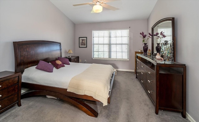 carpeted bedroom with ceiling fan, lofted ceiling, and multiple windows